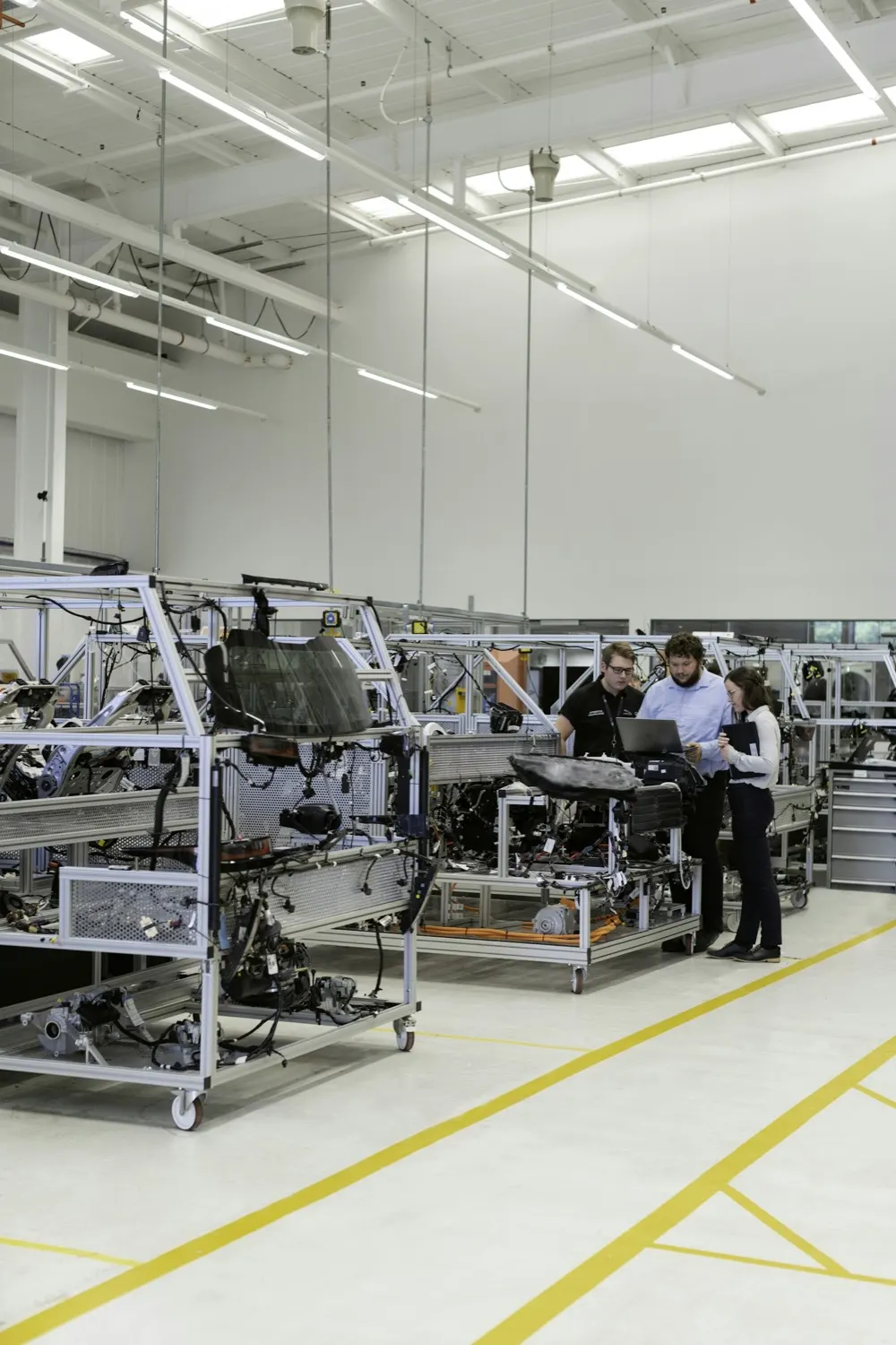 Engineers reviewing carbon reporting requirements together on a factory floor